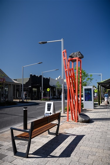 Bus bench in front with Tectonic 2 facing the street