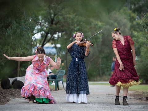 two dancers and violinist at Festival of Mud