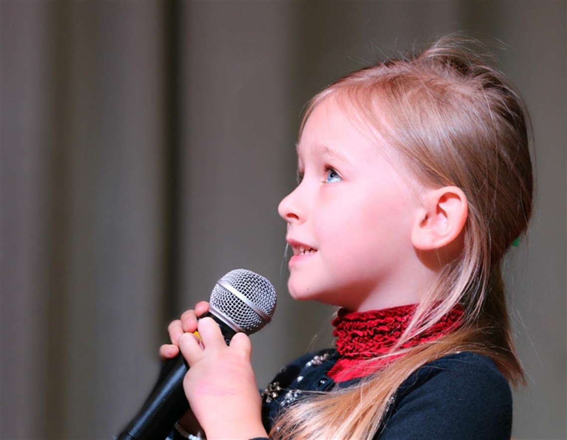 Young girl holding a microphone