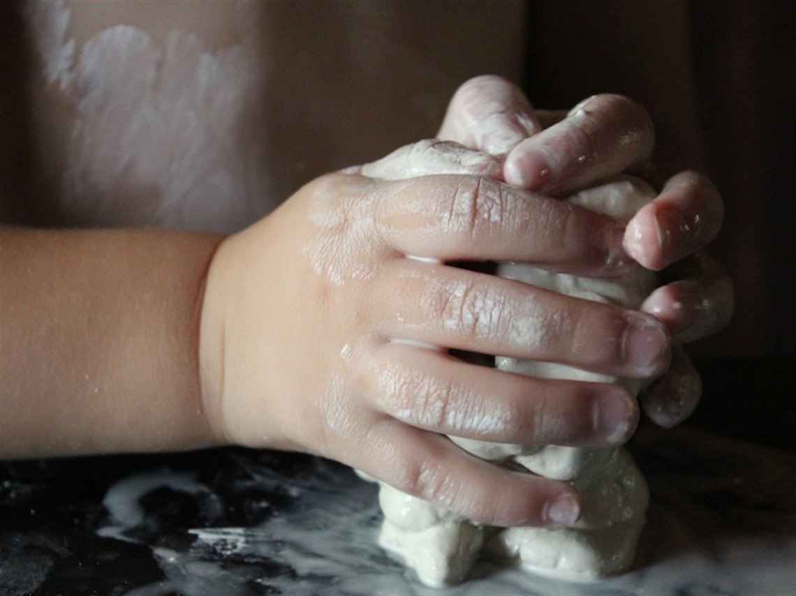 Pottery - child's hands on clay