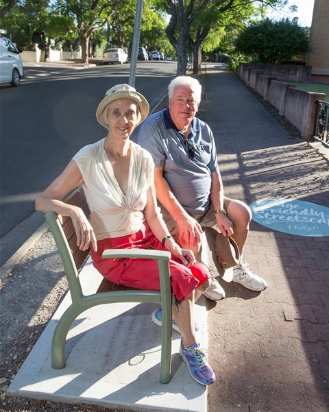 Friendly-streetscapes-couple-resting-on-street-bench.jpg