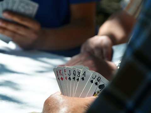 close up of playing cards held in a hand