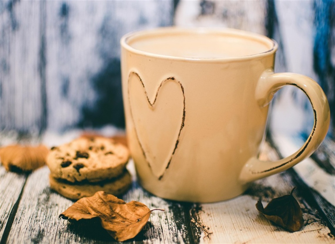 A hot beverage in a mug with a heart on it