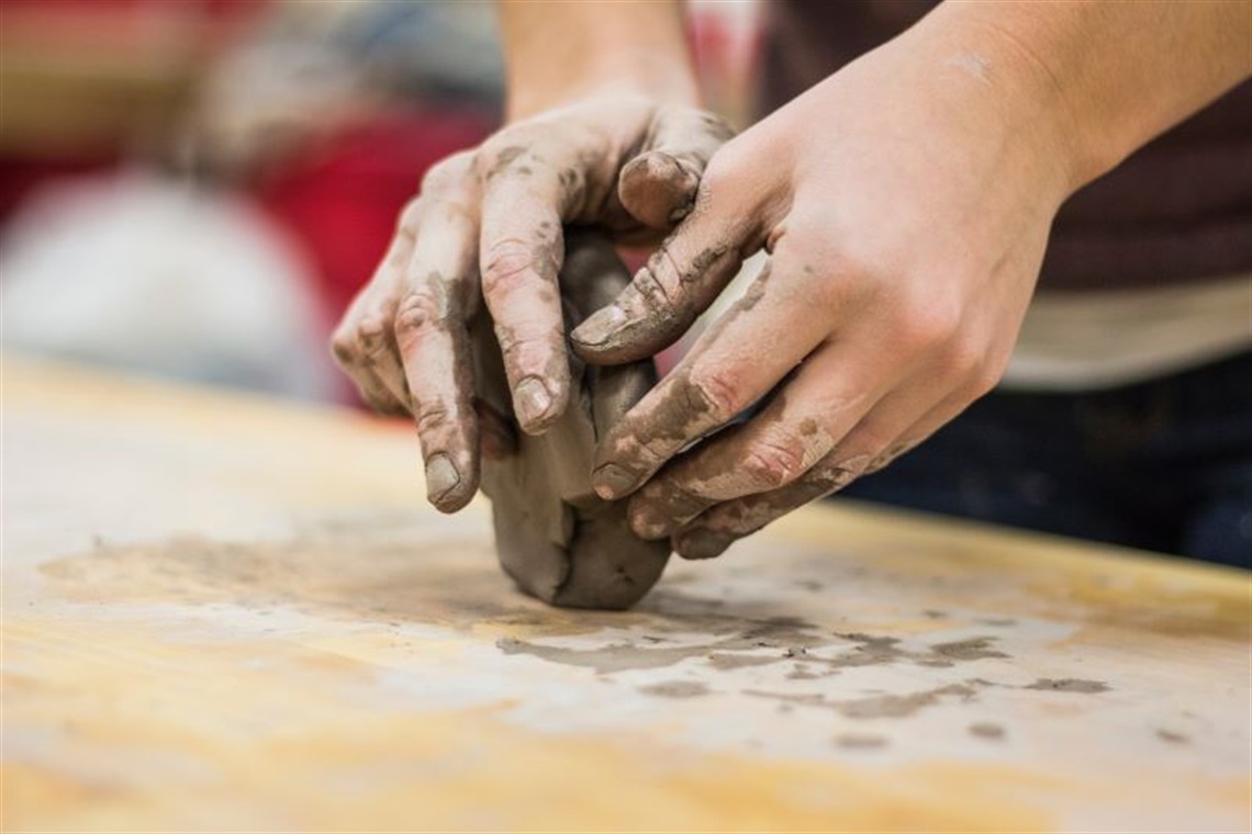 hands using clay