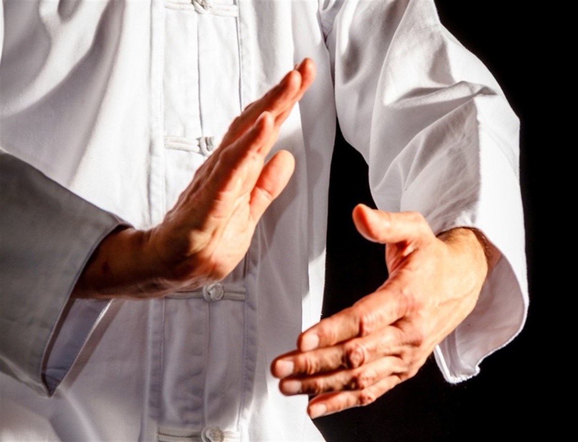 Hands in front of a body in a tai chi pose