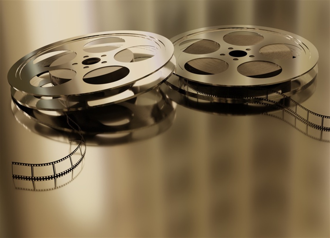 film reels discarded on a gold background