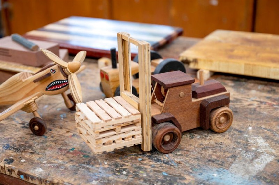 photo of woodwork items including toy truck and plane