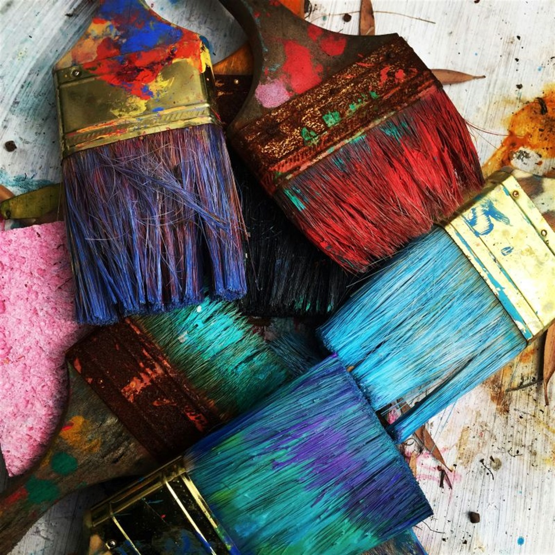image of paint brushes filled with pigment