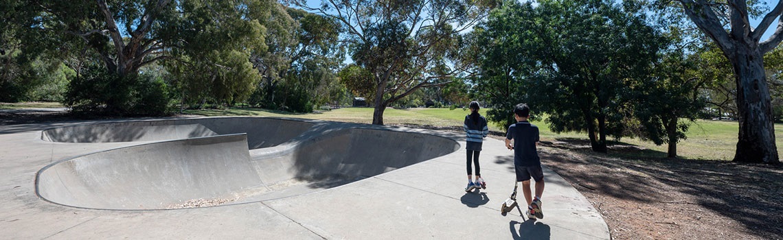 Ridge Park children riding scooters at skate park