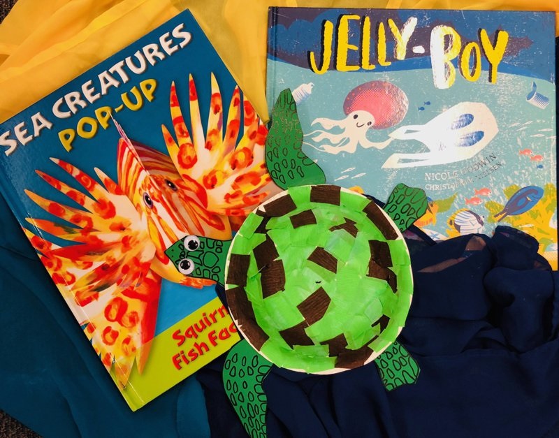Example of turtle craft made from cardboard and paper, pictured with sea creature books