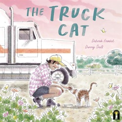 a truck driver is bobbed down petting a cat
