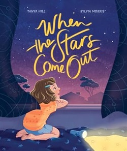 a little girl gazes up at a purple starry sky