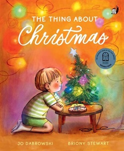 Illustration of a young boy kneeling at a small table, with a tiny christmas tree and one small, wrapped present on it
