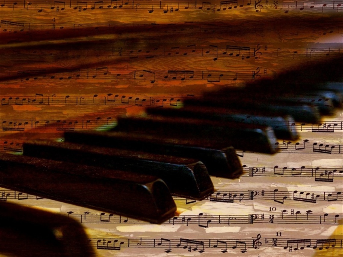 A piano blurring into the distance with written music overlaying the image