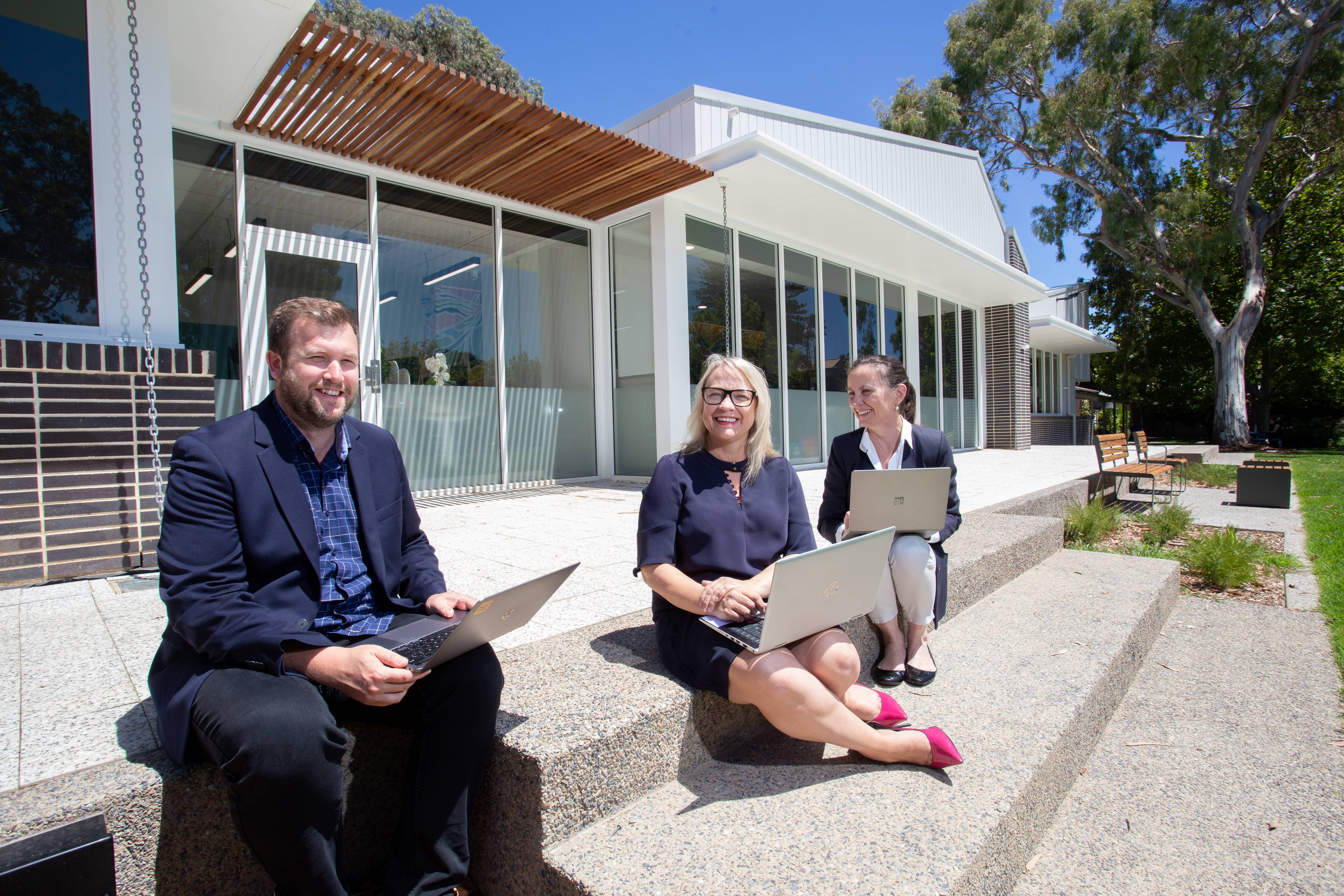 Local business operators in front of Edmund cottages