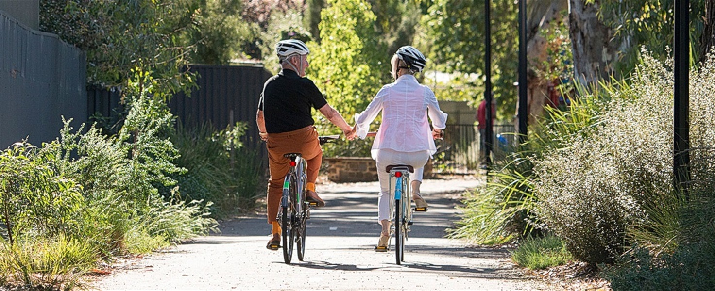 senior-couple-bicycling-pathway-1500-600.jpg