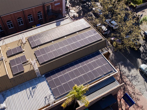 aerial view of solar panels on building roof 