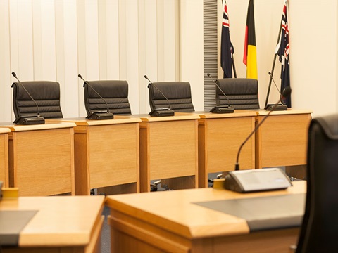chairs desks and microphones in council chamber