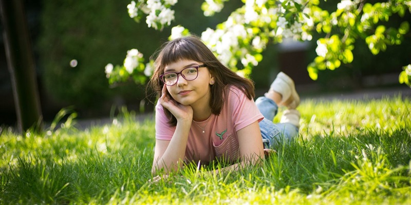 Young teen book club cover image teenager lying on the grass